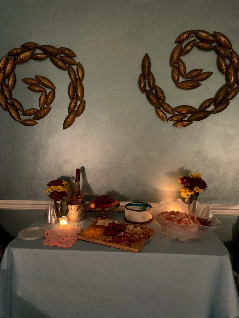 Birthday catering table with cake, charcuterie and bubbly
