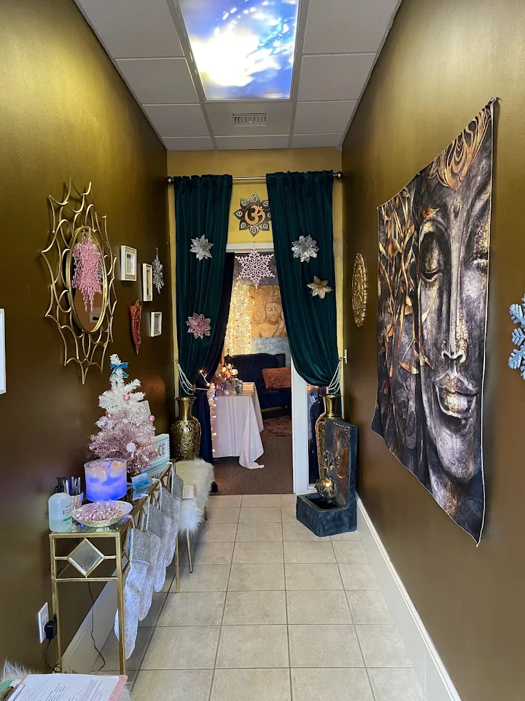 Holiday-decorated entry with Buddha tapestry