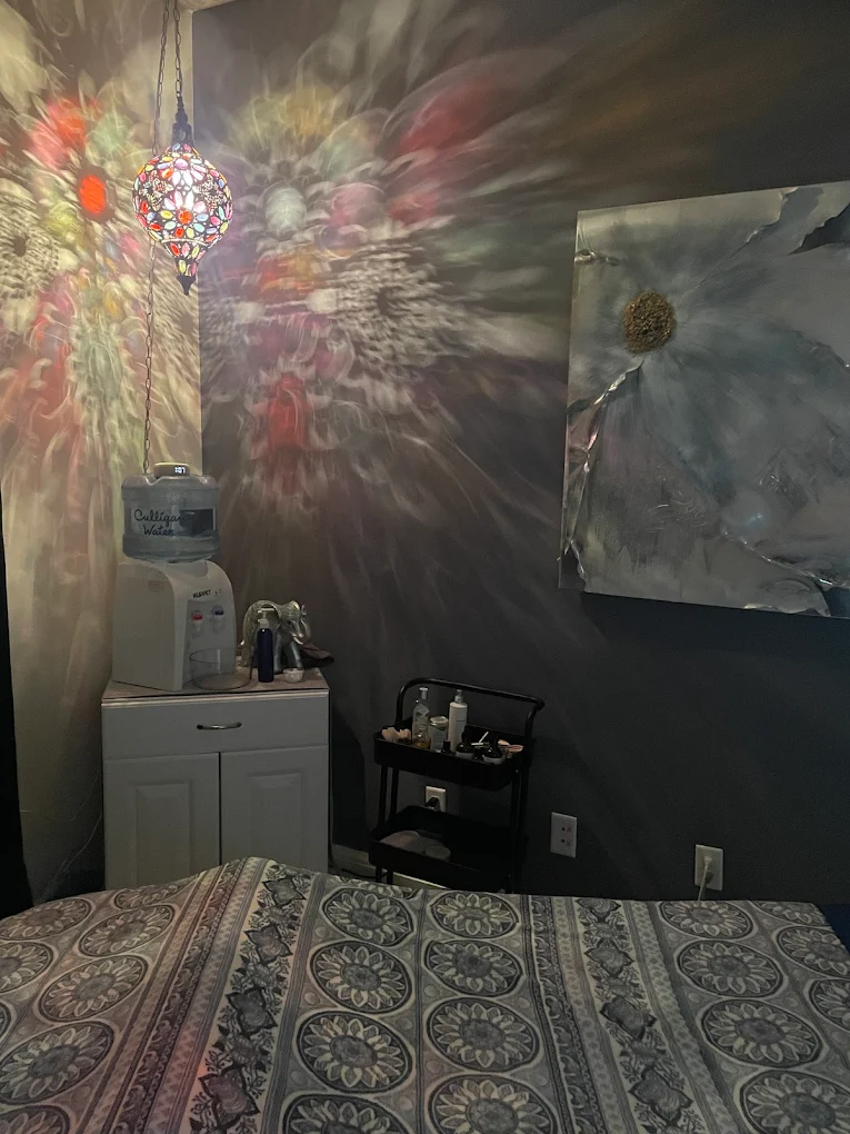 Treatment room glowing under stained-glass mosaic lamp