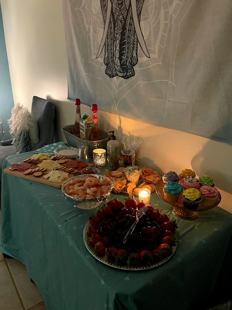 Spa party charcuterie spread under elephant tapestry